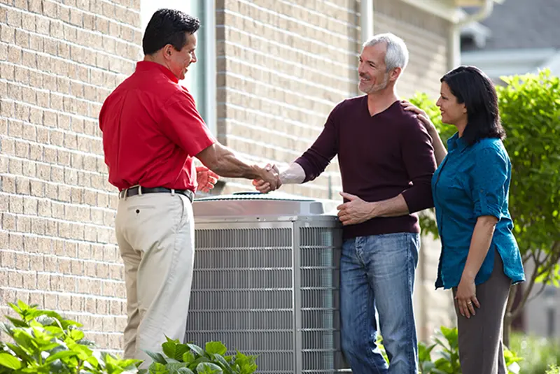 HVAC financing | ZAP Cooling & Heating Bryant Dealer shaking hands with customers by outdoor unit heat pump unit